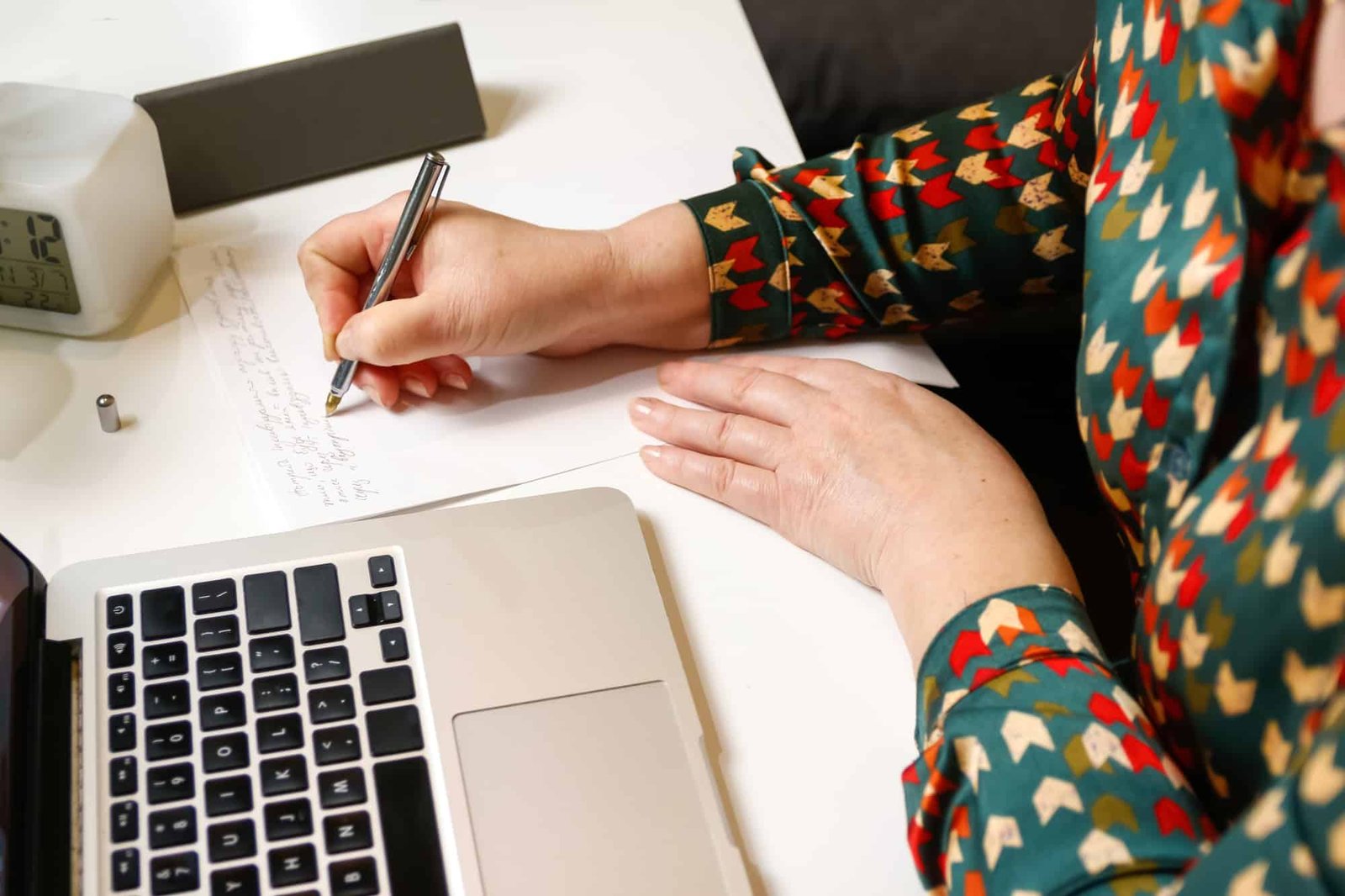 female hand writing by pen. Unrecognizable elegant woman working on computer at office. Start or fin